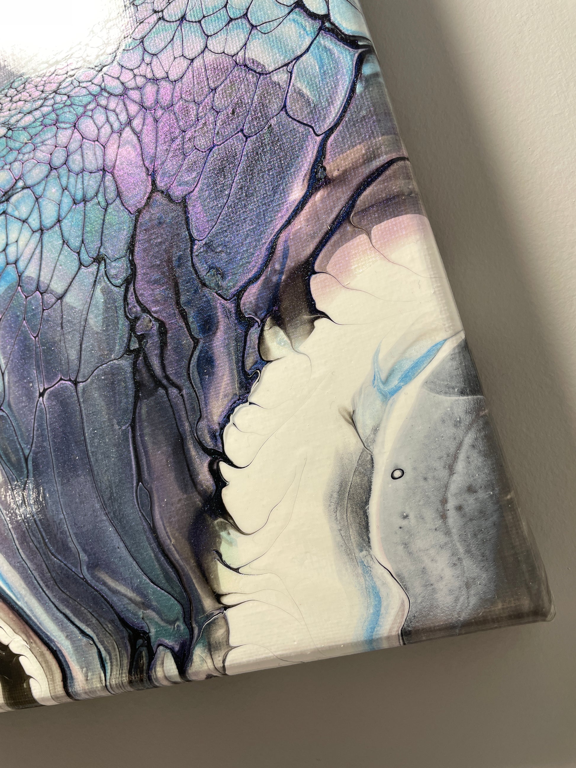 Close-up of a piece of art with abstract patterns on a gray background